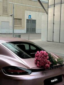 Pink Porsche sports car with a bouquet of roses on the rear, highlighting luxury and elegance – Porsche 911 Review: 9 Powerful Reasons It’s Worth Every Penny.