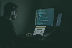 Cybersecurity Trends in 2026 concept image showing a professional working at multiple screens with code, representing digital security, cyber threat monitoring, and advanced cybersecurity technologies.