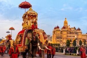 Mysore Dasara procession with decorated elephants at illuminated Mysore Palace